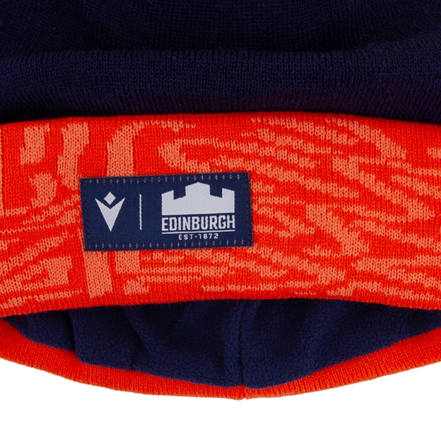 Edinburgh PomPom Beanie 26/27 Navy/Orange/White - Badge Close-up